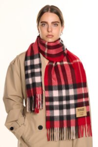 A romantic Valentine’s Day display of pure Scottish cashmere scarves in soft red and ivory tones, styled elegantly with gift boxes