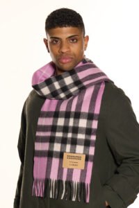 A male model wearing a beige cashmere scarf outdoors.