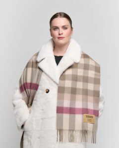 A styled gift display of cashmere scarves in boxes with ribbons, symbolising luxury and thoughtful gifting.